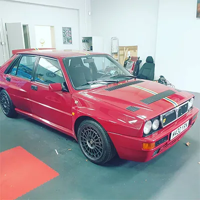 red car racing stripe sideways