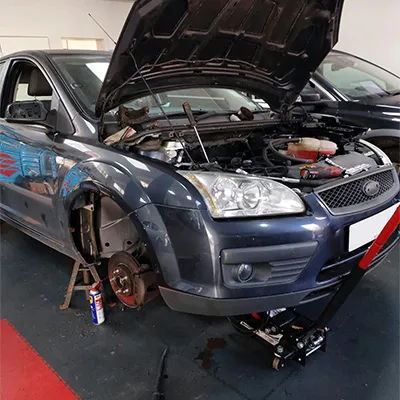 A car is being worked on in a garage.